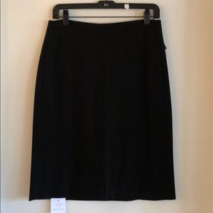 Black pencil skirt with front slit.